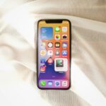 black iphone 4 on white textile