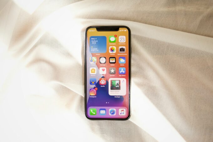 black iphone 4 on white textile