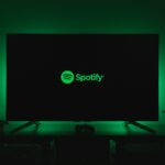 the spotify logo is lit up on a flat screen tv